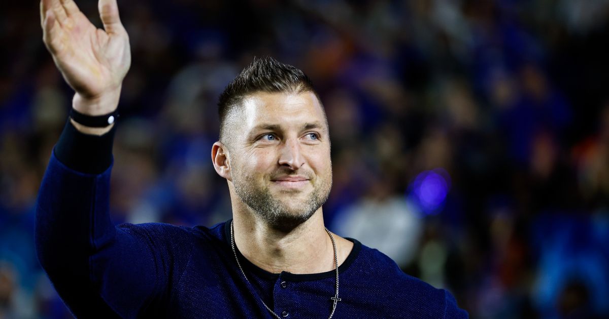 Former Florida Gators Quarterback and Heisman Trophy winner Tim Tebow reacts as he is honored after being inducted into the College Football Hall of Fame Class of 2023 during the first half of a game between the Florida Gators and the Florida State Seminoles at Ben Hill Griffin Stadium on Nov. 25, 2023, in Gainesville, Florida.