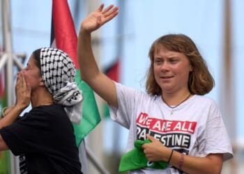 Swedish climate activist Greta Thunberg is seen waving from a boat taking part in a civilian flotilla bound for Gaza as the group left Barcelona, Spain, Aug. 31.
