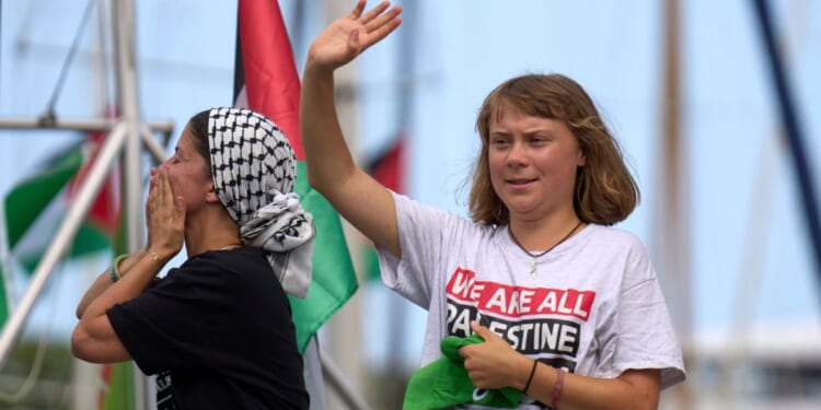 Swedish climate activist Greta Thunberg is seen waving from a boat taking part in a civilian flotilla bound for Gaza as the group left Barcelona, Spain, Aug. 31.