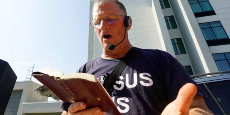 Dr. Coleman Boyd reads from the Bible as he stands outside the Jackson Women's Health Organization clinic in Jackson, Mississippi, on June 29, 2022.