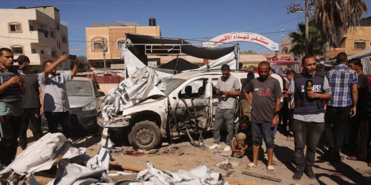 A journalist reports from the scene of an Israeli strike that hit a tent used by displaced Palestinians inside the vicinty of the Shuhada al-Aqsa Hospital in Deir al-Balah in the central Gaza Strip on Oct. 1, 2025.