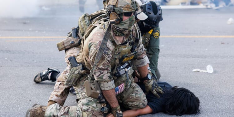 Using helicopters and chemical agents, immigration agents become increasingly aggressive in Chicago