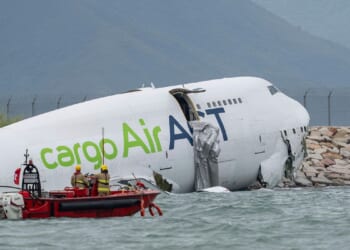 A cargo aircraft skids off a Hong Kong runway into the sea, killing two airport workers