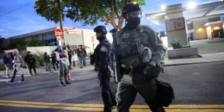 Federal agents, including those with the Department of Homeland Security and the Border Patrol, square off against antifa demonstrators Friday in Portland, Oregon.