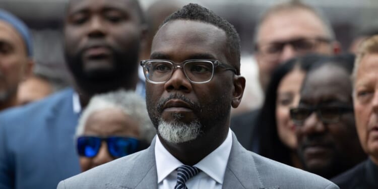 Chicago Mayor Brandon Johnson listens as Illinois Gov. J.B. Pritzker speaks at a news conference to address President Donald Trump's plan to send National Guard troops into the city on Aug. 25, 2025, in Chicago, Illinois.