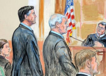 A courtroom sketch of former FBI Director James Comey and his attorneys standing in a federal courthouse in Alexandria, Virginia, on Oct. 8, 2025.