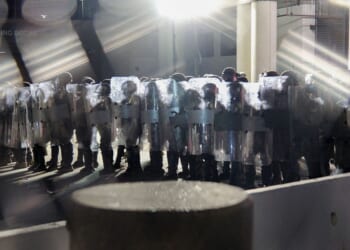 Police in riot gear line up outside the Metropolitan Detention Center in Los Angeles on Sept. 1. Officers confronted demonstrators after hours of anti-ICE protests demanding the abolition of the agency.