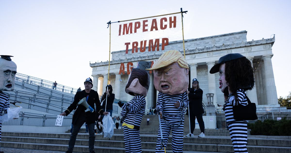 Activists from Free Speech For People dressed as Vice President J.D. Vance, Secretary of Homeland Security Kristi Noem, President Donald Trump, and White House Deputy Chief of Staff Stephen Miller participate in a rally at the Lincoln Memorial on Oct. 17, 2025, in Washington, D.C.