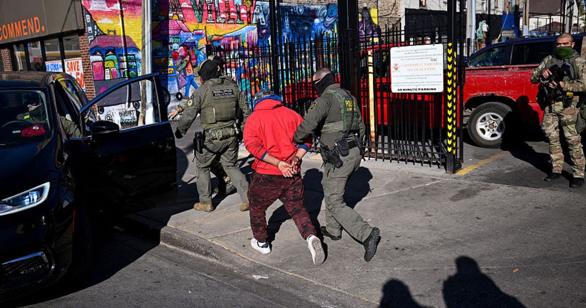 U.S. Border Patrol officers arrest an individual Nov. 6 in the Little Village neighborhood of Chicago, Illinois. (Joshua Lott - The Washington Post / Getty Images)