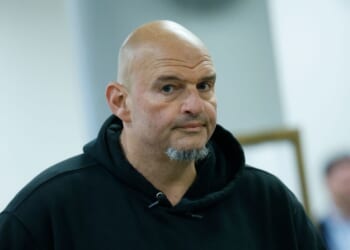 Sen. John Fetterman, a Democrat from Pennsylvania, walks to vote at the U.S. Capitol on Oct. 8, 2025, in Washington, D.C.