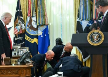 President Donald Trump looks on after a man fainted during an announcement about weight loss drugs in the Oval Office of the White House in Washington, D.C., on Nov. 6, 2025.