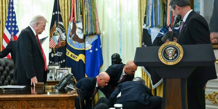 President Donald Trump looks on after a man fainted during an announcement about weight loss drugs in the Oval Office of the White House in Washington, D.C., on Nov. 6, 2025.