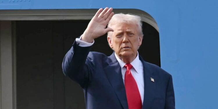 President Donald Trump waves as he boards Air Force One after talks with Chinese President Xi Jinping at the Gimhae Air Base, located next to the Gimhae International Airport in Busan on Oct. 30, 2025.
