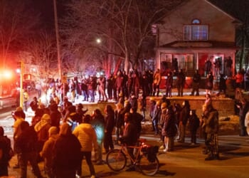 Residents confront federal agents following a shooting incident on Jan. 14, 2026, in Minneapolis, Minnesota.