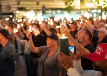 Attendees hold candles during a candlelight vigil and prayer event for Turning Point USA founder Charlie Kirk on Sept. 10, 2025, in Seattle, Washington.