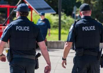 Police officers walk through a city park on June 14, 2025, in Salt Lake City, Utah.