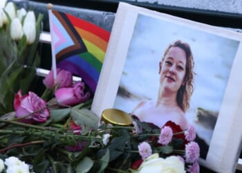 Flowers and candles are seen at a vigil for Renee Nicole Good in front of the United States embassy on Jan. 11, 2026, in Berlin, Germany.