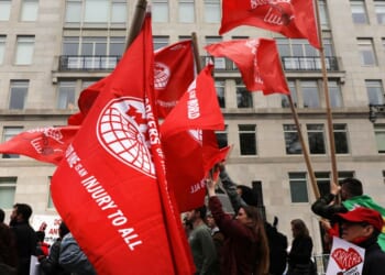 Members of the Democratic Socialists of America gather outside of a Trump-owned building on May Day on May 1, 2019, in New York City.