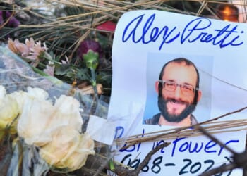 Flowers are left at a makeshift memorial in the area where Alex Pretti was shot dead a day earlier by federal immigration agents in Minneapolis, Minnesota, on Jan. 25, 2026.