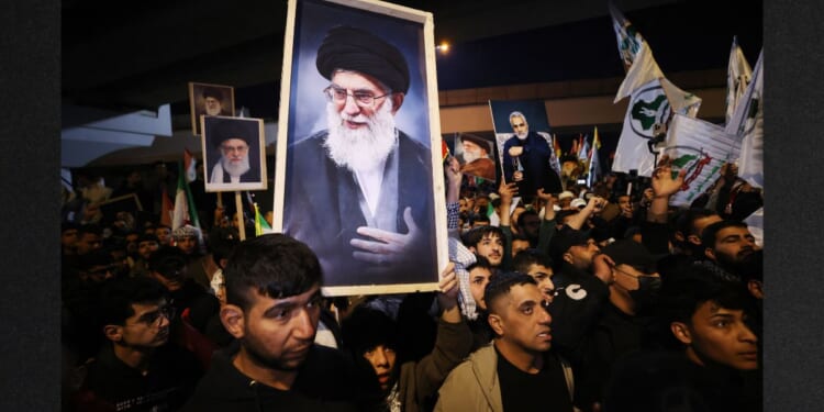 Iraqi Shiites carry a portrait of Iran's Supreme Leader Ayatollah Ali Khamenei during a protest Saturday against U.S. and Israeli attacks on Iran. News sources were reporting that Khameni has be