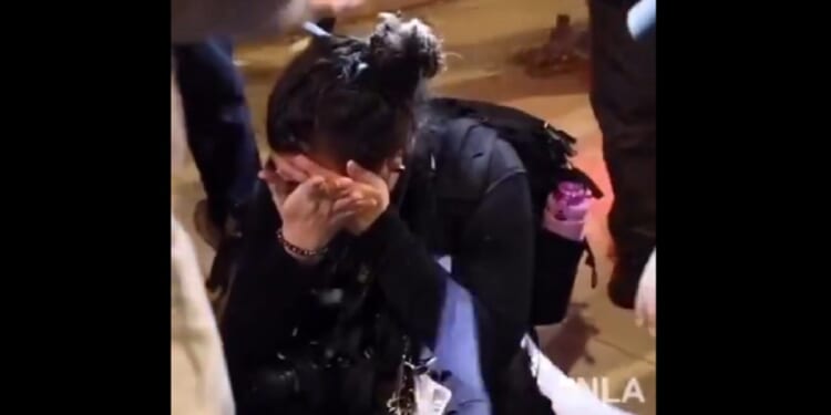 A journalist documenting Los Angeles mob violence holds her hands over an eye after being attacked Saturday night.