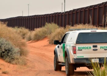 U.S. Border Patrol agent drives near the U.S.-Mexico border fence in Santa Teresa, New Mexico on April 6, 2016.