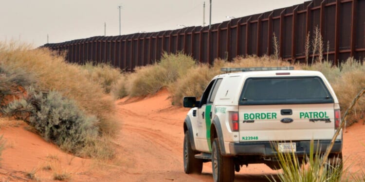 U.S. Border Patrol agent drives near the U.S.-Mexico border fence in Santa Teresa, New Mexico on April 6, 2016.