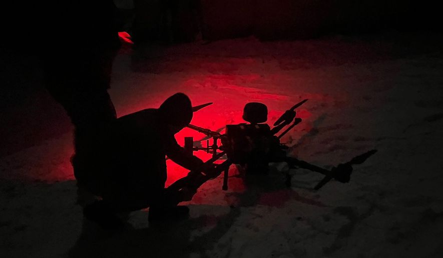 As night falls on the frontline in southeastern Ukraine, the members of the 423rd Unmanned Systems Battalion watch and listen to the rhythmic thud of distant explosions. (Guillaume Ptak/The Washington Times)
