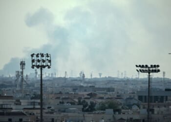 Smoke rises from an area in the direction of Al Udeid Air Base, which houses the Qatar Emiri Air Force and foreign forces including the United States, in Doha on Feb. 28, 2026, following a reported Iranian strike.