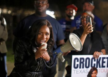 Rep. Jasmine Crockett speaks with supporters outside a polling station on Feb. 27, 2026, in Dallas, Texas.