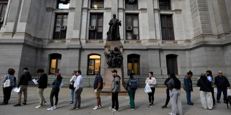 Philadelphia residents wait in a line around city hall to cast their ballot on the last day of early voting on Oct. 29, 2024, in Philadelphia, Pennsylvania.
