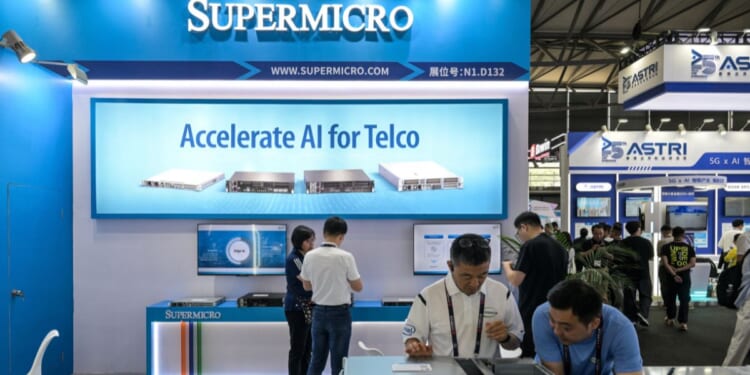 Attendees of the Mobile World Congress visit the Supermicro stand in Shanghai on June 18, 2025.