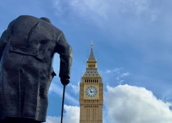 Big Ben and the Houses of Parliament with a statue of Sir Winston Churchill seen from behind in the foreground on March 4, 2024, in London, England.