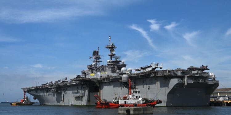 The US Navy's USS Tripoli amphibious assault ship is seen during a port call at the Port Area in Manila on Sept. 27, 2022.