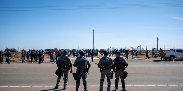 Texas State Troopers secure the area after dispersing a crowd protesting Immigration and Customs Enforcement at the South Texas Family Residential Center on Jan. 28, 2026, in Dilley, Texas.
