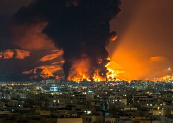 Smoke and flames rise at the site of airstrikes Saturday on an oil depot in Tehran, Iran.