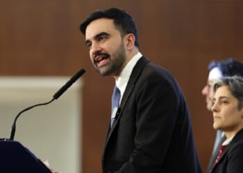 New York City Mayor Zohran Mamdani speaks into a microphone at a community meeting last week at New York City's Fordham University.