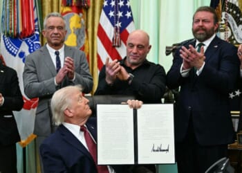 FDA Commissioner Marty Makary, Health and Human Services Secretary Robert F. Kennedy Jr., media personality Joe Rogan, W. Bryan Hubbard, CEO of Americans for Ibogaine, and former Navy SEAL Marcus Lutrell applaud after President Donald Trump signed an executive order in the Oval Office of the White House in Washington, D.C., on April 18, 2026.