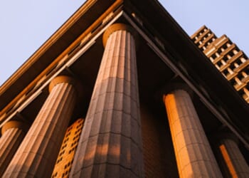 A Neoclassical building stands.