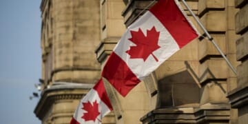 Canadian flags wave at the Capitol Building in Ontario, Canada.