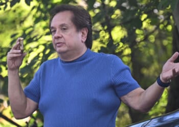 George Conway speaks on the phone outside John Bolton’s Bethesda, Maryland home as raid takes place on August 22, 2025.