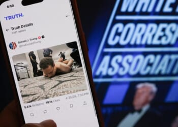 A hand holds a phone with a photo of Cole Tomas Allen, the man accused of attempting to murder President Donald Trump and other administration officials. at the White House Correspondents' dinner on April 25, 2026 in Washington, DC.