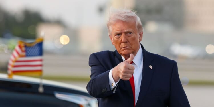 President Donald Trump waves to the media after walking off of Air Force One at Miami International Airport on April 11, 2026, in Miami, Florida.