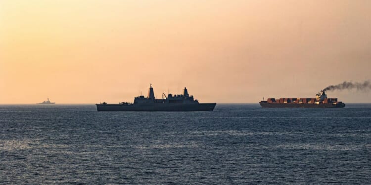 In this handout photo provided by U.S. Central Command, U.S. forces patrol the Arabian Sea near M/V Touska on April 20, 2026, after firing upon the Iranian-flagged vessel that the U.S. accused of attempting to violate the U.S. naval blockade of Iranian ports near the Strait of Hormuz.