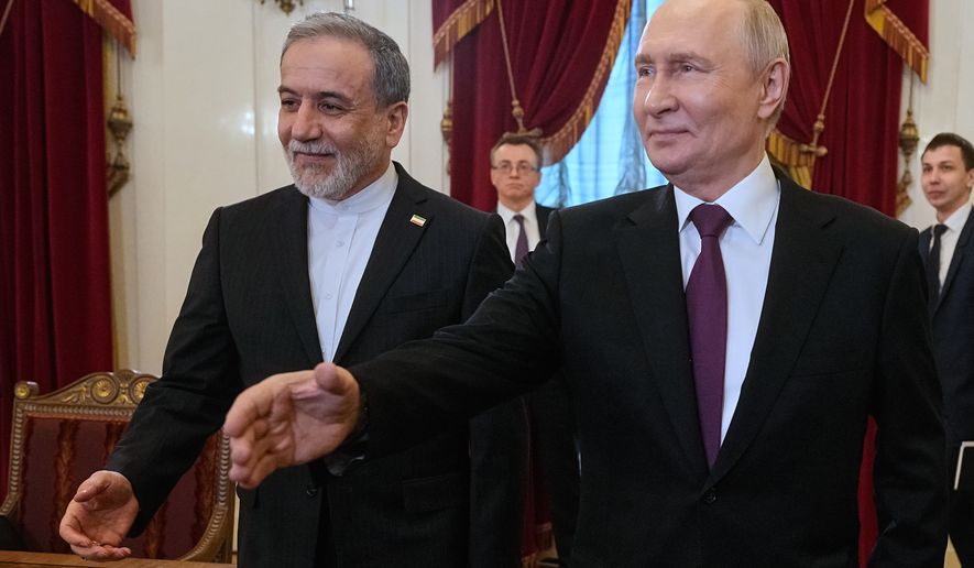 Russian President Vladimir Putin, right, and Iranian Foreign Minister Abbas Araghchi walk to attend the talks at the Boris Yeltsin Presidential Library, in St. Petersburg, Russia, Monday, April 27, 2026. (AP Photo/Dmitri Lovetsky, Pool)