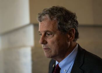 Then Sen. Sherrod Brown, D-Ohio, looks off to the side.