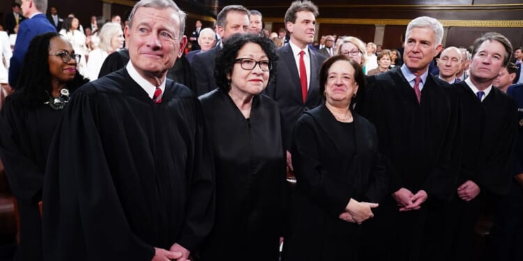 Supreme Court Chief Justice John Roberts, left, and Associate Justices Sonia Sotomayor, Elena Kagan, Neil Gorsuch, and Brett Kavanaugh stand on the House floor ahead of the annual State of the Union address by then- President Joe Biden before a joint session of Congress on March 7, 2024.