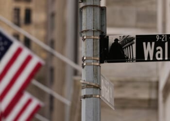 A Wall Street sign is seen outside of the New York Stock Exchange in New York, Monday.