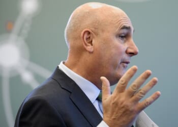 Hugh Grant, CEO of Monsanto, looking away from the camera