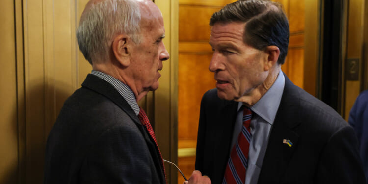 Sen. Peter Welch (D-VT) and Sen. Richard Blumenthal (D-CT) speak outside of the Senate Chambers.